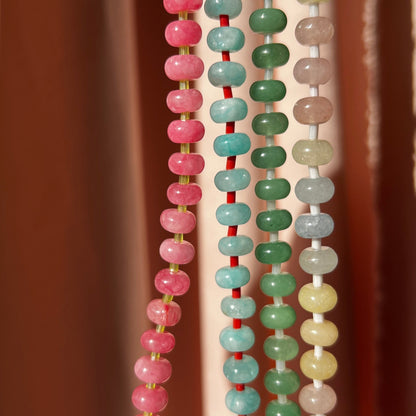 close- up of the whole collection of handbeaded necklace made using button shaped beads of  agate stones with tiny colorful glass beads. trending chunky beaded necklace for summer