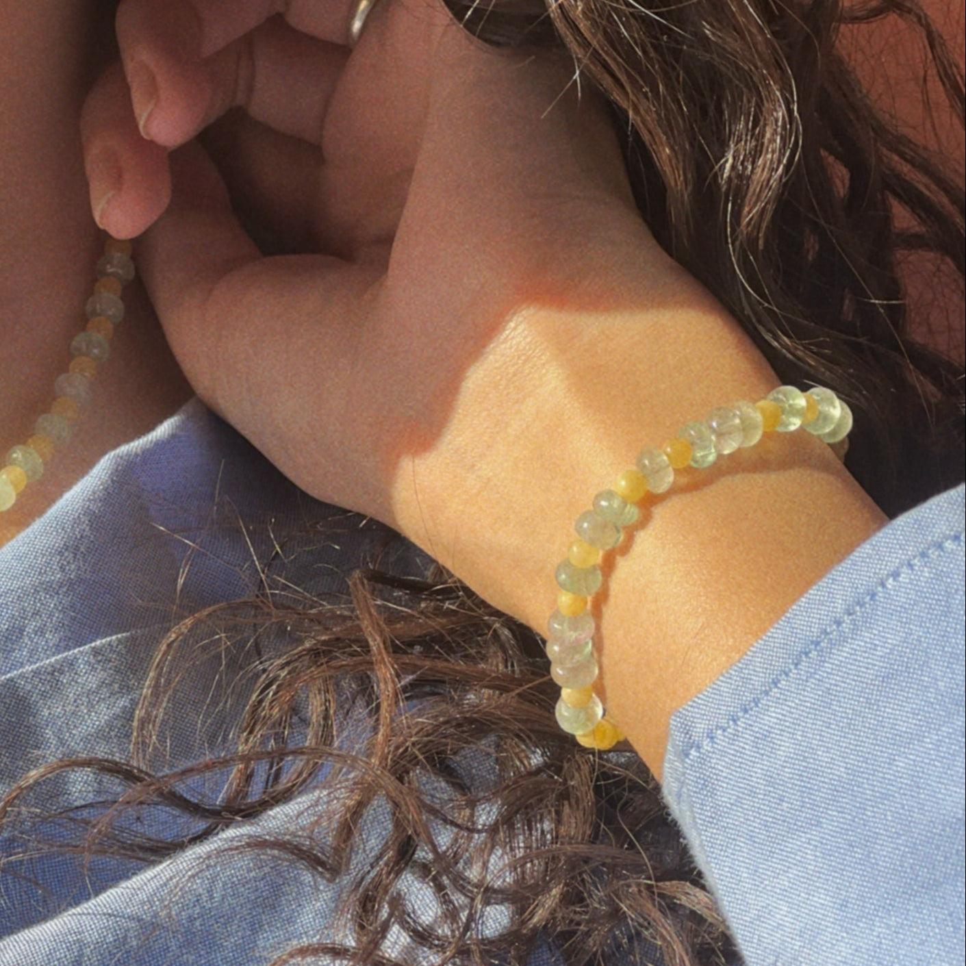 hand-beaded Citrine Skies bracelet in butter yellow agate stones and tourmaline blue stones.
 A soft summer day, captured in stone.
Inspired by the golden warmth of citrine sunsets and the tranquility of clear skies. Blends butter yellow and sky blue tones in a dreamy, refreshing palette. Handcrafted with natural jade and tourmaline  gemstones and finished with 925 sterling silver clasp.  Material: Natural jade stones - Length: 42 cm - 925 sterling silver clasp. 
