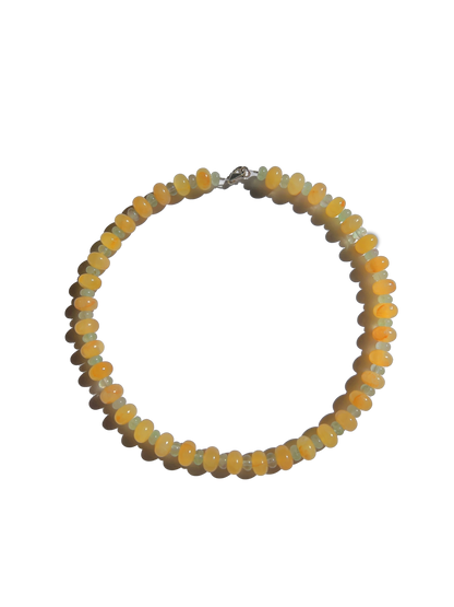 Citrine Skies Necklace A soft summer day, captured in stone.Inspired by the golden warmth of citrine sunsets and the tranquility of clear skies. Blends butter yellow and sky blue tones in a dreamy, refreshing palette. Handcrafted with natural jade gemstones and finished with 925 sterling silver clasp. Featuring: Material: Natural jade stones - Length: 42 cm - 925 sterling silver clasp