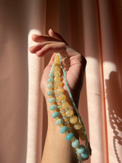 close-up shot of the hand-beaded Citrine Skies Necklace collection in butter yellow agate stones blue stones