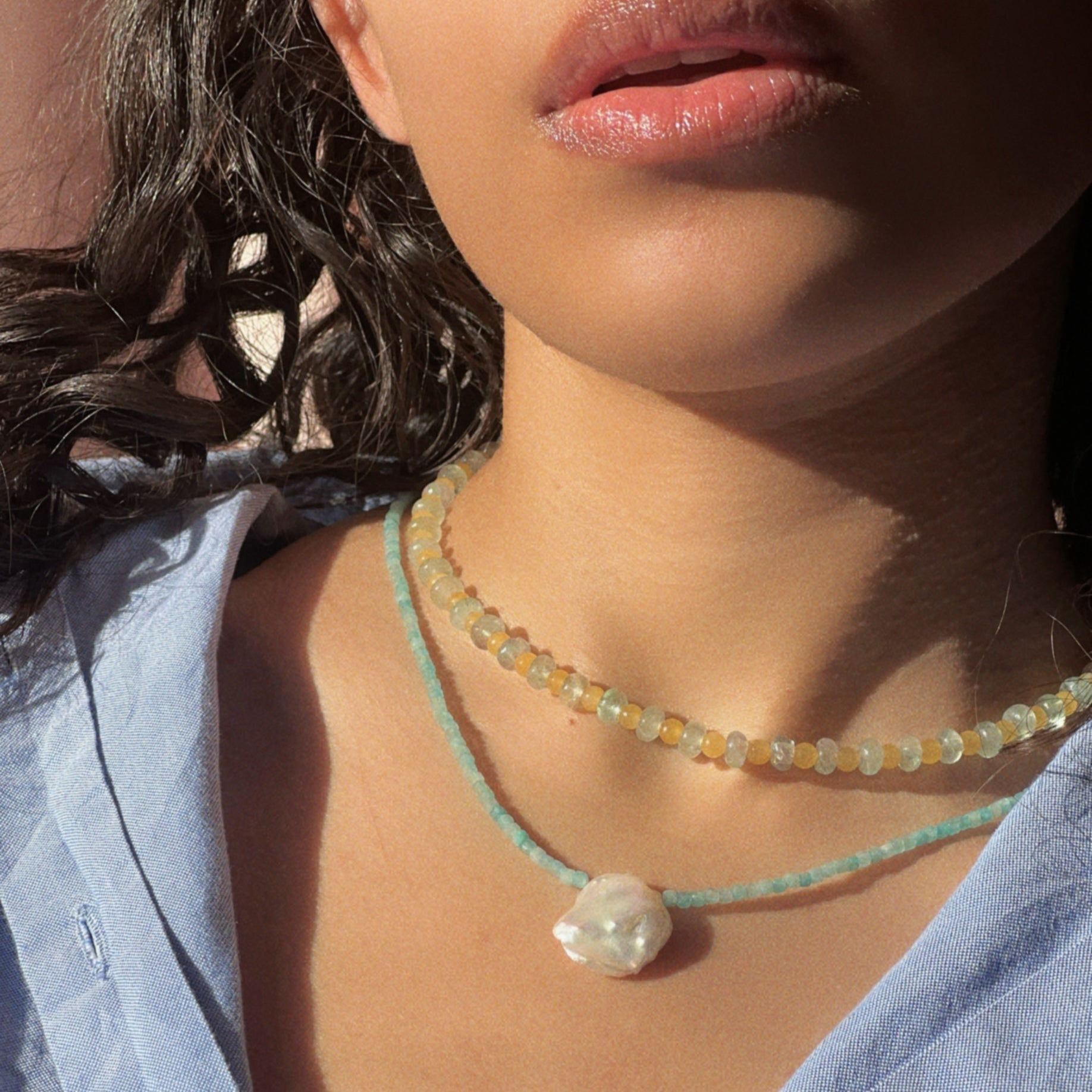 Styling a hand-beaded Citrine Skies necklace in butter yellow agate stones and tourmaline blue stones layered with the aquamarine necklace with a dangling large natural stone. the perfect summer color combo
 A soft summer day, captured in stone.
Material: Natural jade stones - tourmaline - aquamarine - natural pearl.
Length: 42 cm - 925 sterling silver clasp. 
