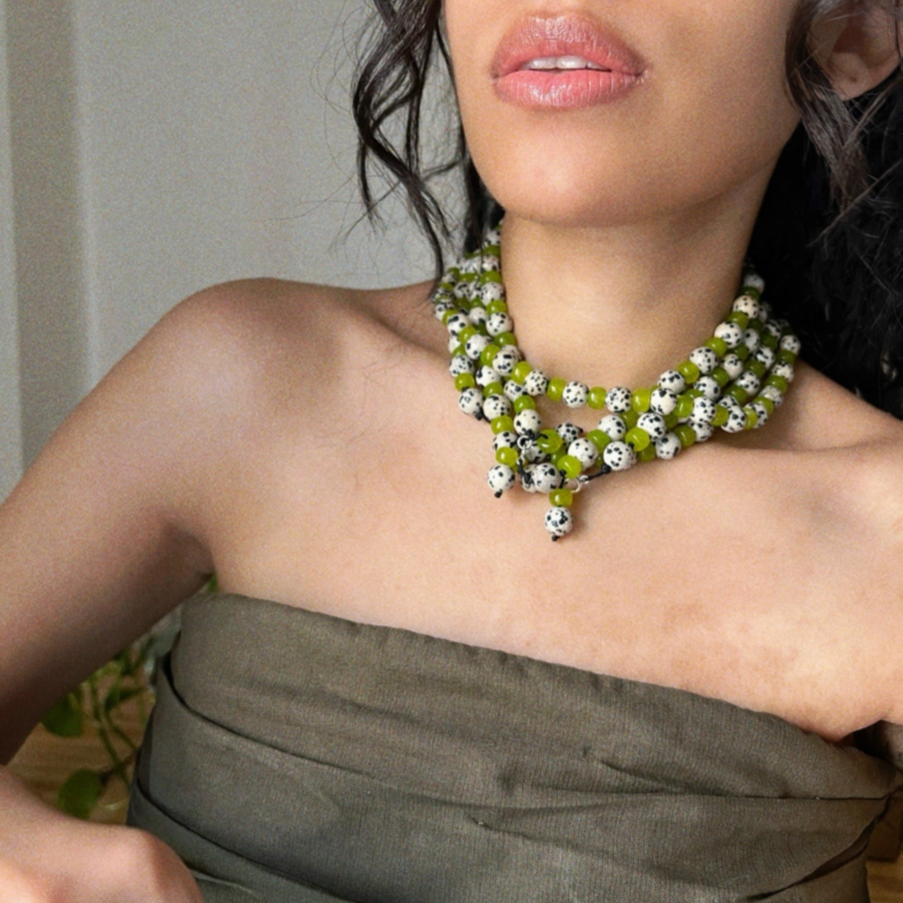 wearing multiple green jade and dalmatian jasper beaded necklaces inspired from the character "cruella"