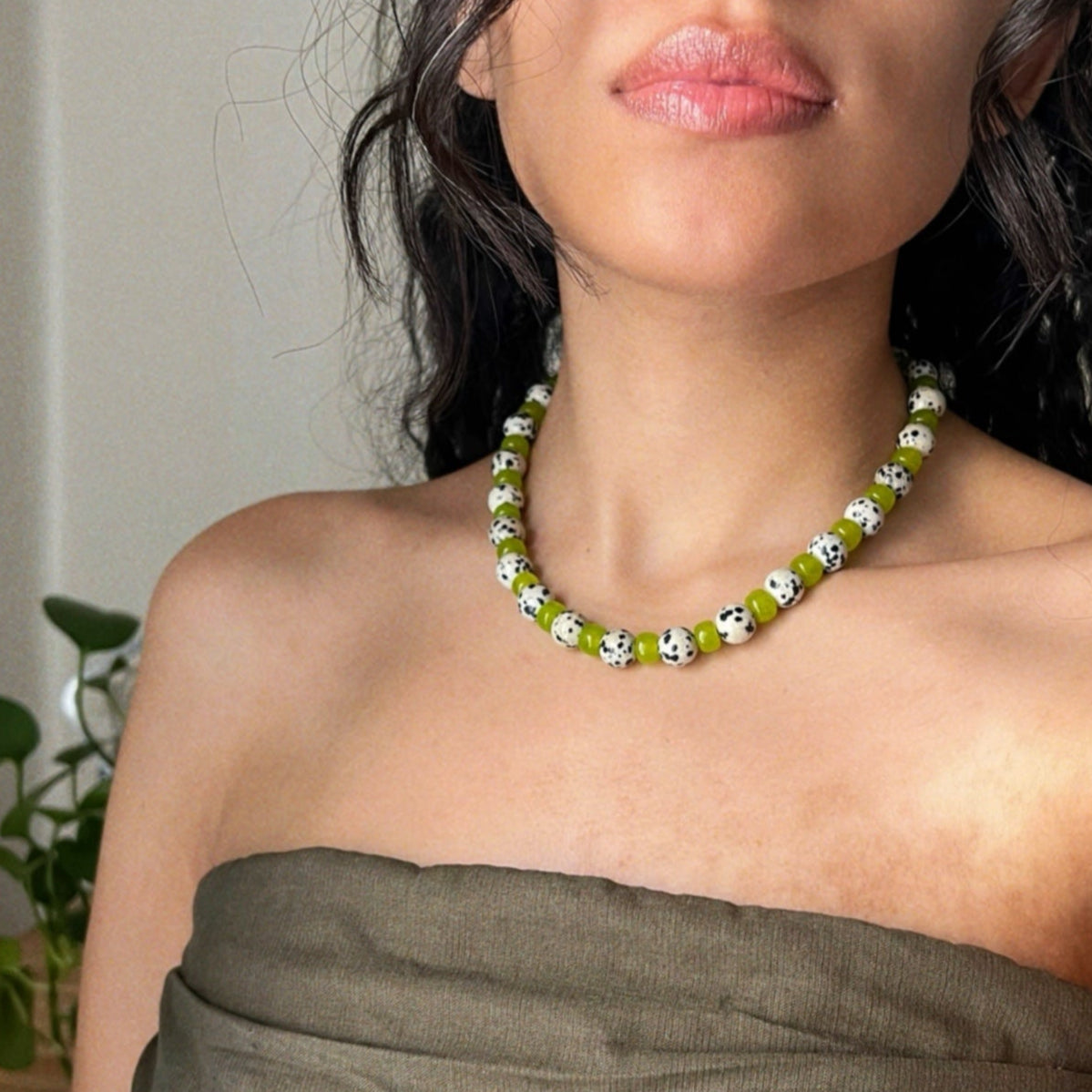 wearing a green jade and dalmatian jasper beaded necklace inspired from the character "cruella"