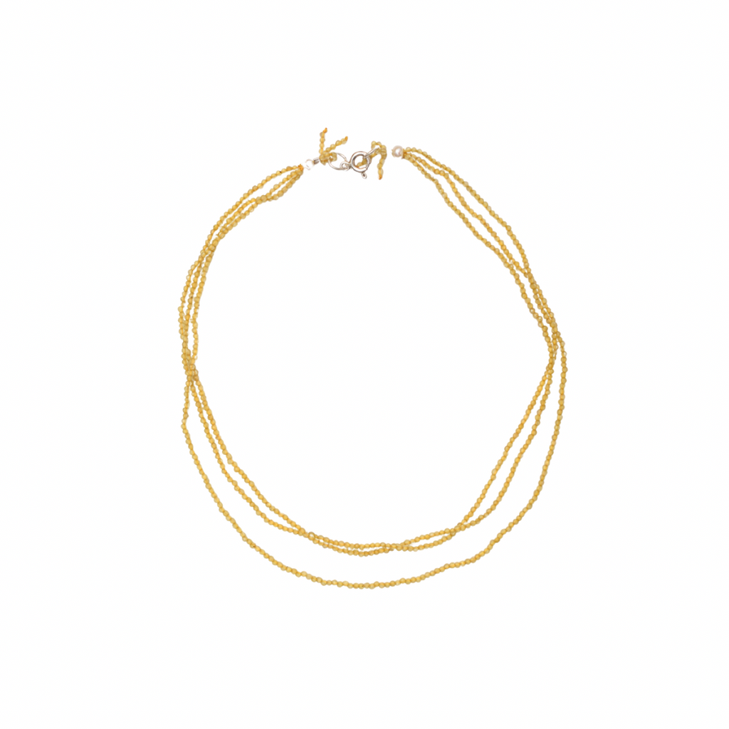 yellow necklace on a white background