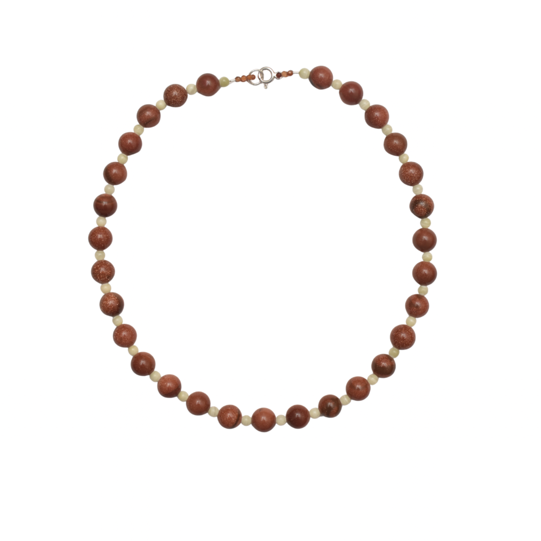 Hand-strung necklace with round golden brown sunstones and small mint green Jade stones with white background.